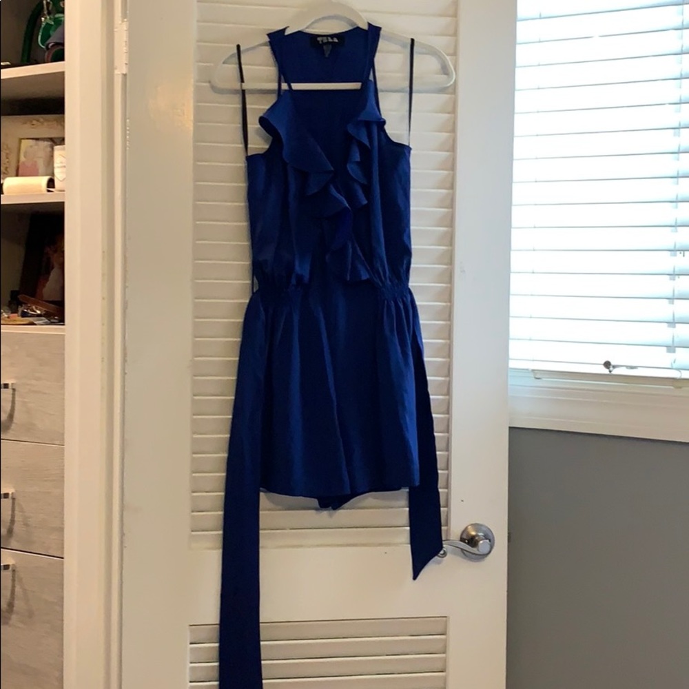 Blue romper. Pretty ruffle detail and tie at waist